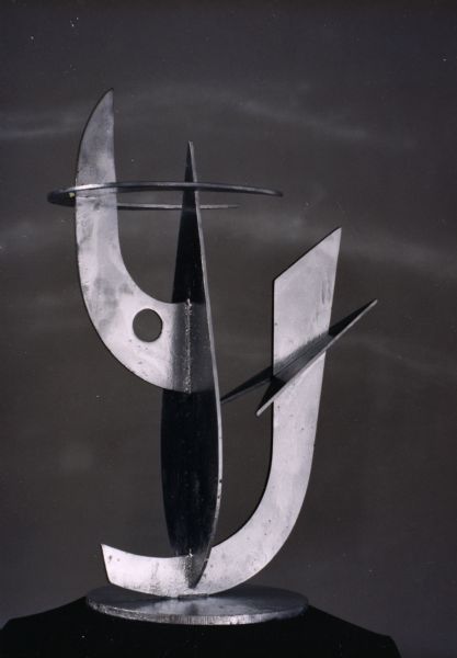 3-D abstract cut metal sculpture, resting on black velvet. It stands 31 inches high.