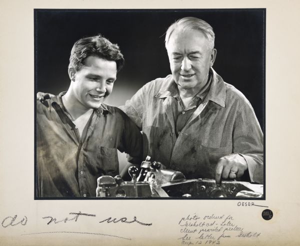 Illustration of an airbrushed composite photograph picturing an older worker standing with his arm around a young man and pointing to a machine. 