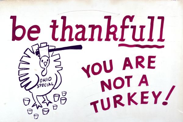 A cartoon line drawing in black of a turkey with a hatchet coming down on it neck, with "Ohio Special" written on its breast. Includes the phrase, in red letters: "Be thankfull (sic.) you are not a turkey!"
