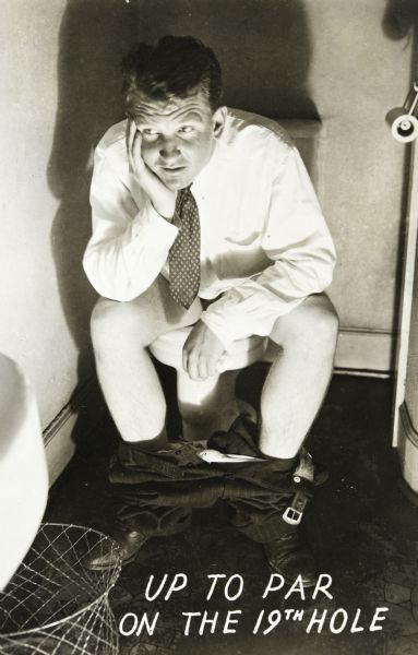 Self-portrait of Sid Boyum using a slave unit for a flash. He is wearing a shirt and necktie sitting on a toilet with his pants down around his ankles. He is resting his head in his hand. Caption at bottom: "Up to par on the 19th hole." 