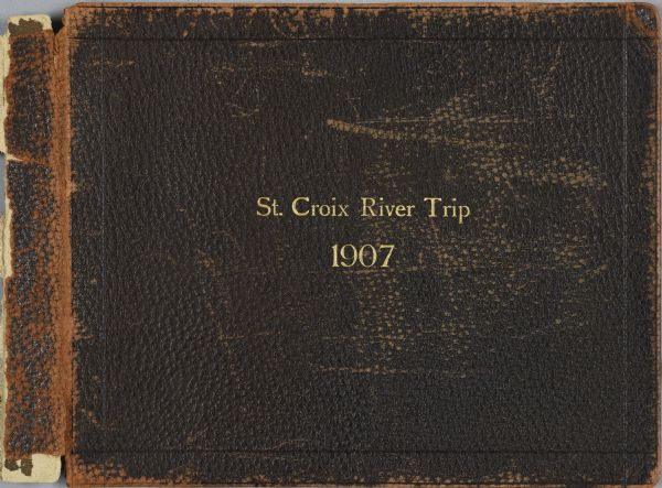 The brown leather cover of Howard Greene's journal stamped "St. Croix River Trip 1907" in gold.