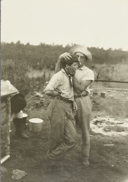 A quiet moment between Clay and Doc. They're standing by the river, and Doc is smoking a cigarette.