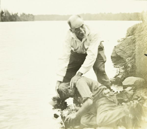 Another view of Doc Copeland dipping Jack's face in the Chippewa River to wash off the toothpaste.