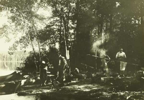 The Gang at their camp in a shady spot by Burntside Lake. The canoes are in the water on the left.