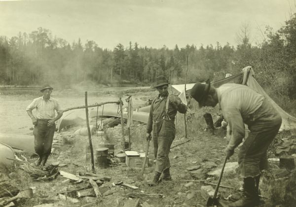 The Gang split wood for the cooking fire at their camp by Sturgeon Lake. 