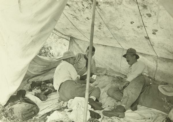 L-R: Doc Copeland, Carl, and Bill Marr playing poker in the tent.