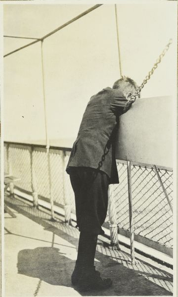 Carl looking over the rail of the steamship “Easton”. "Easton was owned by the United States and Dominion Transportation Company which provided regular service on Lake Superior using the “Easton” and sister ship “The America”.
