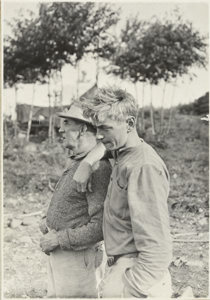Clay Judson leaning on the shoulder of Dr. Ernest Copeland. They are standing outdoors.