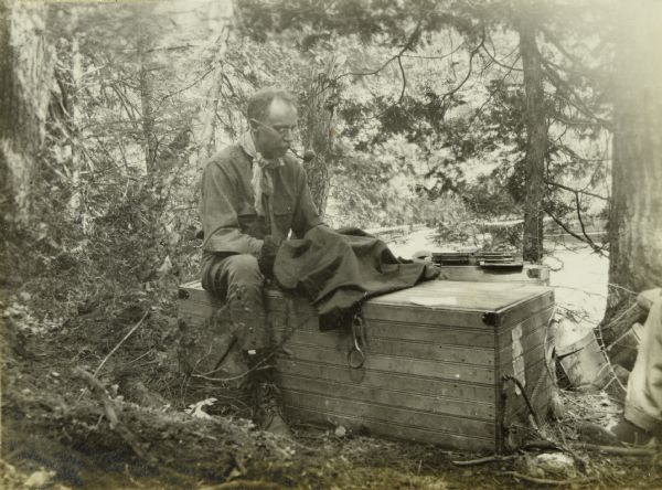 Howard Greene (Dad) is changing negative plates in his large format camera on the banks of the Presque Isle River.