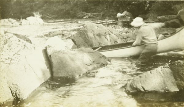 One of The Gang guiding his canoes through a rough spot of rocks and cascades on the Presque Isle River.