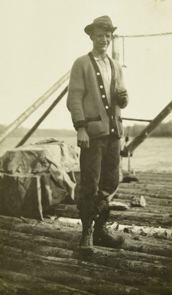 Canadian Fire Ranger J.B. MacDonald standing on the dock by Fall Lake.