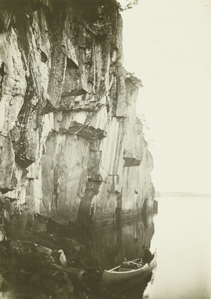 One of The Gang's canoes in the lee of a sheer cliff on Lac La Croix.