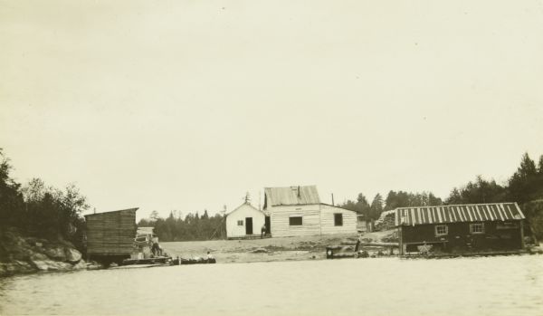 A view from the water of several buildings along the shoreline in Kettle Falls.