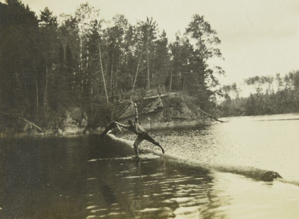 B (William Norris) beginning to fall off the log boom into the lake. This is in the Narrows between Sand Point and Namakan Lakes.