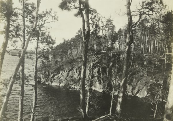 A view through trees to the palisades of a rocky island on Namakan Lake.