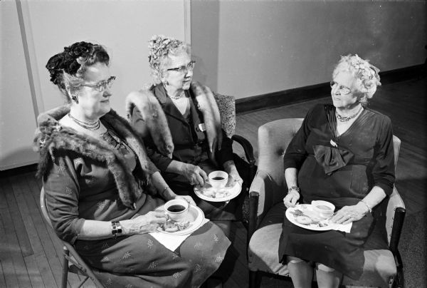 The Women's Societies of Christian Service of the Methodist Churches of Madison observed the society's 20th anniversary with a "Heritage Tea."  Sayda Pettersen, left, a past president, spoke on "Our Heritage" and gave recognition to the charter members present. She is seated with Jessie Harloff and Emma Harston. The afternoon's program included music by a trio and a devotions led by Rhena Baumeister.