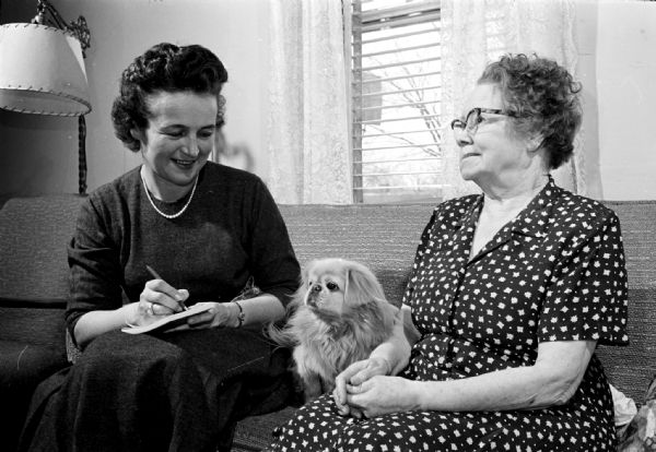 Barbara Bruemmer (left) writing a letter for Mrs. Floyd L. Dudley, who is a patient of the Visiting Nurse Service. Barbara is a volunteer "friendly visitor" for the Visiting Nurse Service which is a Red Feather agency in Madison.