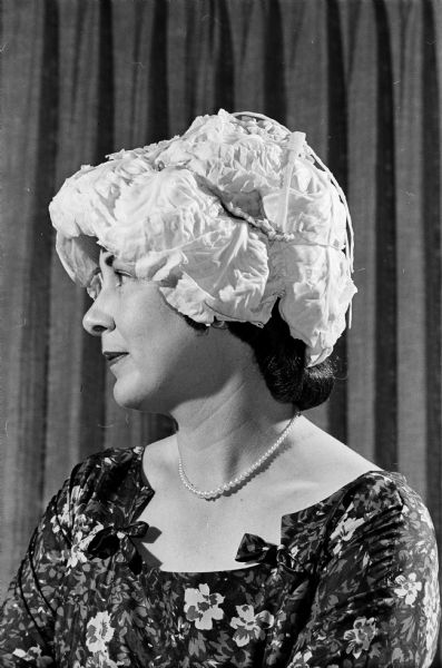 The "prettiest hat" at the Blackhawk Country Club Womens' Mad Hat event went to Mrs. Warren C. (Barbara) Bogel of 4518 Wakefield Street. She used fresh cabbage leaves with carrot strips as accents for her flattering chapeau.