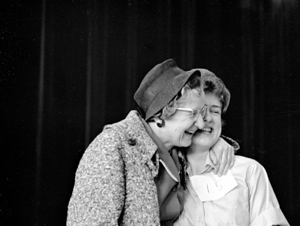 A happy Julie Matthews (right) receiving a hug from her mother, Mrs. Harlan Matthews (left) of Platteville, after winning the Iowa County Spelling Bee. Julie went on to compete against 70 other city and county spelling champions.