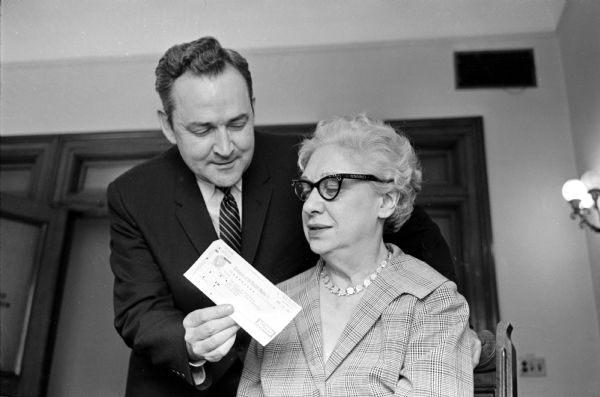 State Deputy Attorney General Nathan Heffernan handing State Treasurer Dena Smith a check for $750,000. The check represents money owed the state from the Federal Swamp Grant Act of 1850 for over 100 years of litigation on swamp land claims between the Federal government and the State of Wisconsin.