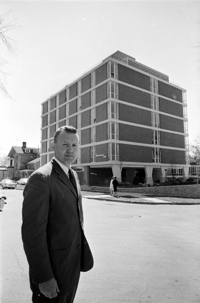 Manager James Payton standing across the street from the recently completed Madison Inn motor hotel at Frances and Langdon Streets.