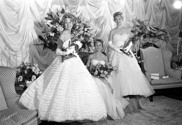 The newly crowned Miss Madison, Charlotte Ann Gibson, sitting in the middle at the crowning ceremony in the East High School auditorium. At the left is first runner-up Ellyn Otterson, and second runner-up Judith Ann Thielmann at the right. The contest was sponsored by the Madison Junior Chamber of Commerce.