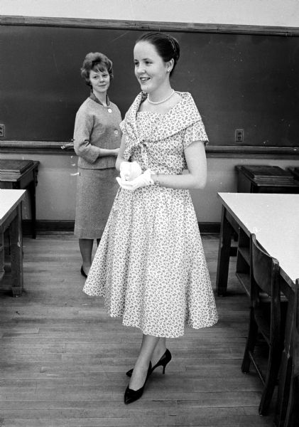 Mary Frances Kelly, 1105 Emerald Street (foreground), and Georgia Nelson, 314 Merrill Crest (background), model for the West High Girls' Club "Around the Fashion Clock" annual style show in the high school auditorium.