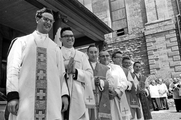 Bishop William P. O'Connor ordains seven men to the priesthood at St. Raphael Cathedral Church. Shown (L-R) are: Revs. Fred Jones, Oak Park, Ill; George Fox, Edgerton; John Hebl, Portage; Donald Beckius, Portage; Donald Murray, 1716 Kendall Ave., Madison; Gerald Vosen, Merrimac; and Donald Moran, 30 Dixon St.