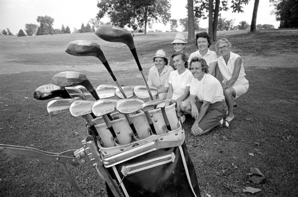 Polly Erickson, wife of the University of Wisconsin basketball coach John Erickson, won her second straight women's city golf championship. Flight winners pictured after the final round at Nakoma Golf Course are, left to right: First row: Lucia Gronbeck, second flight; Jo Ann Walker, first flight; Polly Erickson, championship flight. Second row: Patricia Henshaw, fourth flight; Dorothy Steiro, fifth flight; Marion Doege, fourth flight; and Dorothy Steiro, grandmother of Patricia Henshaw.