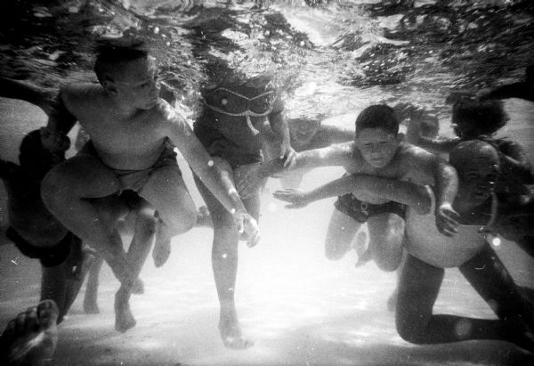 Underwater photograph of several youth learning to swim in a Sun Prairie pool.