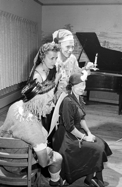Posing in amusing costumes representing well-known songs of the day are (seated) Francis and Betty Coon and (standing) Dorothy and Kenneth Lindquist.