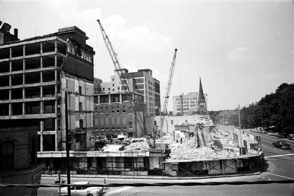 A view from West Main Street of the site of the oldest part of Park Hotel which workmen had just completed razing. The view, looking northwest, shows the spire of Grace Episcopal Church and the Gay building beyond it. The razed section, which fronted Capitol Square, was built in 1871.