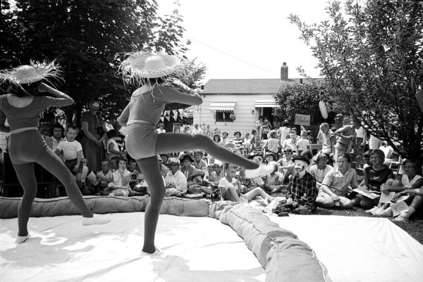 Marueen McGilligan performing a progressive dance at the Sunset Hills neighborhood children's circus, a fund-raiser for the American Nursing Research Foundation. The event was held in the backyard of Frank and Muriel Wagner, 229 N. Hillside Terrace. A good crowd is watching the show.