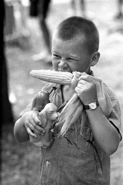 John Lynch (10) of Sun Prairie is shown biting into an ear of corn at the annual corn festival.