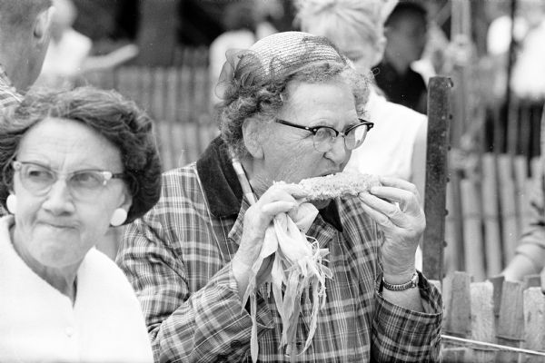 Mary Heisler of Sun Prairie carefully eats an ear of corn at the annual corn festival.
