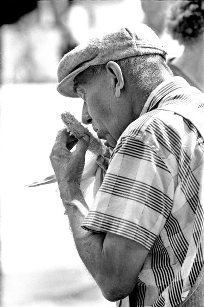 An unnamed rural DeForest area man is shown eating an ear of corn at the Sun Prairie Corn Festival.
