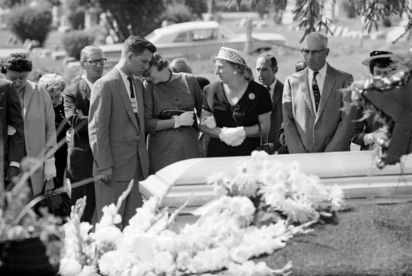 Mrs. James C. Jantz, wife of the slain policeman, holding the arm of her mother, Mrs. Roger Keith, and leaning on the shoulder of her brother, Jerome Boyer.