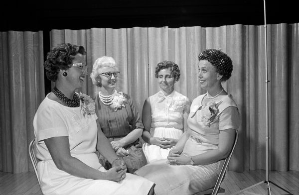 Four members of the Methodist Hospital School of Nursing class of 1936 that was honored at the annual banquet of the Alumni Association sitting together. From left to right are Carolyn McCormick, Ella Schaller, Mrs. Myron Klotz of Plain, and Mrs. Nick Sossong (?) of Milwaukee.