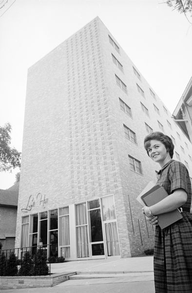 Kay Wilgus, a University of Wisconsin freshman student from Arcadia, California, standing in front of the newly opened Lowell Hall, a private women's resident hall at 610 Langdon Street.