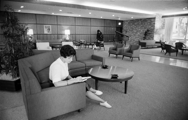 Joy Feinberg, a University of Wisconsin freshman from Mansfield, Ohio, reading in the living room of the newly opened Lowell Hall, a private women's residence hall at 610 Langdon Street.
