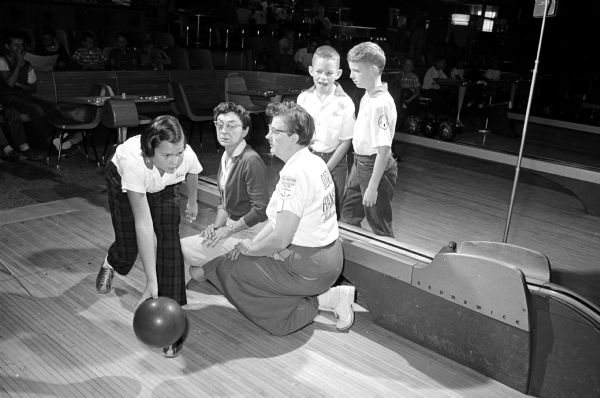 Madison's Junior Bowling League program begins the season at the Bowl-A-Vard Lanes & Burr Oaks Bowl on Saturday mornings and afternoons. Cheryl Crary (11) is observed by Marcy Kleinsteiber and Doris Hanson as David Crary (9) and Bob Marten (11) look on.