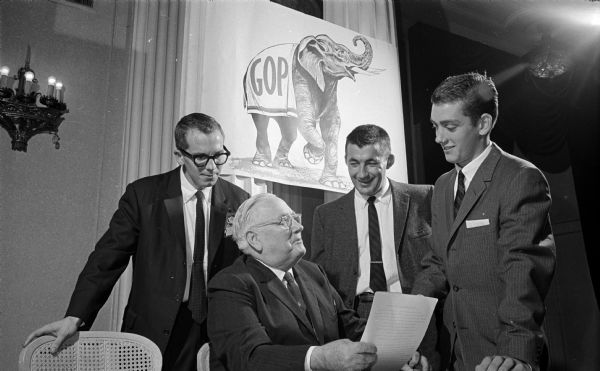 Wisconsin's senior United States Senator Alexander Wiley is greeted by three members of Dane County Young Republicans. The greeters are, left to right: Peter Anderson, Al Neumann, and Richard Wright.