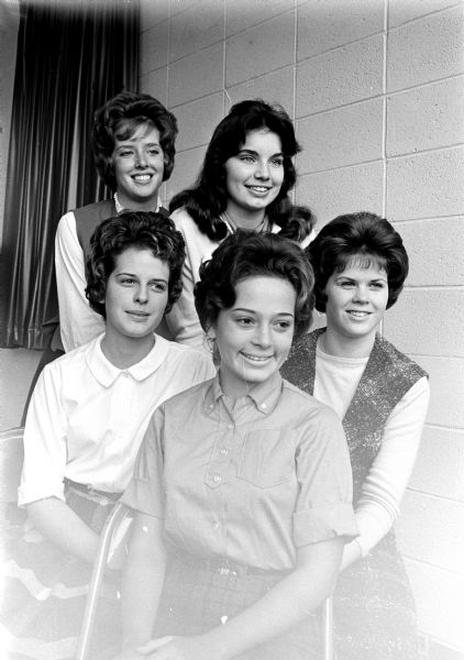 The five members of the court of honor for Monona Grove high school's Homecoming are shown. Sitting in front are Judy Jordan; Jennifer Simons of Jamaica, an American Field Service exchange student living with the Onsager family; and Sue Onsager. In the back are Peggy Marshall and Viki Van Hoof.