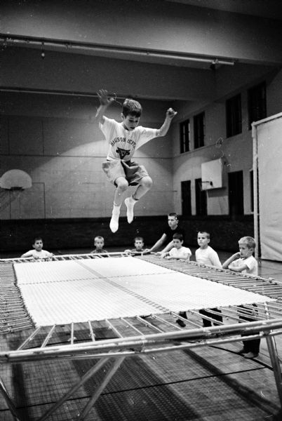 The boys' program at the Madison YMCA is supported by the United Givers. Here a boy is jumping on the trampoline.