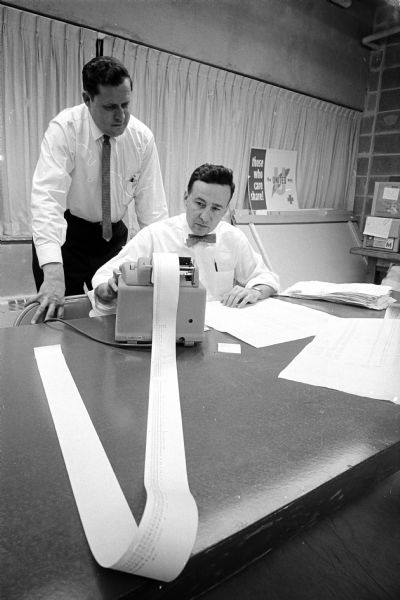 The Madison Chapter of Certified Public Accountants, donate about three nights of work a week to auditing the United Givers fund. Among them are Donald Nelson, left, and Jack Gibson.