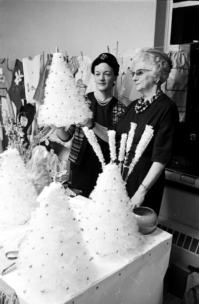 Mrs. C.J. (Kath) Key, 423 North Carroll Street, left, and Mrs. Olive, MacKay, 2115 Madison Street, hand-crafted Christmas trees at the Harvest Festival at Grace Episcopal Church. St. Faith's Guild of the church sponsored the festival.