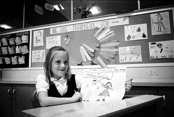 Second graders at Hoyt School make pictorial displays for Thanksgiving to show what they are thankful for. Edith Birdsall (7), daughter of Mr. and Mrs. John J. Birdsall, 2821 Van Hise Avenue, shows her drawing.
