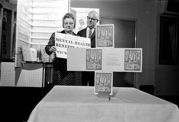 The Wisconsin Association for Mental Health and the Madison Eagles Lodge co-operate to sell Christmas cards to raise funds for the rehabilitation of mentally ill persons at the state mental hospitals.
The cards are for sale at the Eagles Club, 1236 Jenifer St.
Shown looking over a sale poster are (L-R) Mrs. Victor Buckles, 2625 Scofield St., president of the Eagles women's auxiliary; and Mr. W.E. Menze, 1837 Winchester St., Eagles lodge secretary.