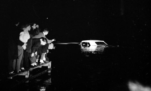 The car of Californian Charles E. Reid lying submerged in Lake Wingra at the end of Knickerbocker Street after a police chase resulting from him holding up an east side service station.