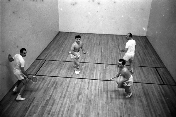 Madison's white-shirted Bob Westervelt, left, and Red Wilson have Ted Wahl, center, and Bill Pire of Eau Claire on the run to a victory in the national paddleball tournament.